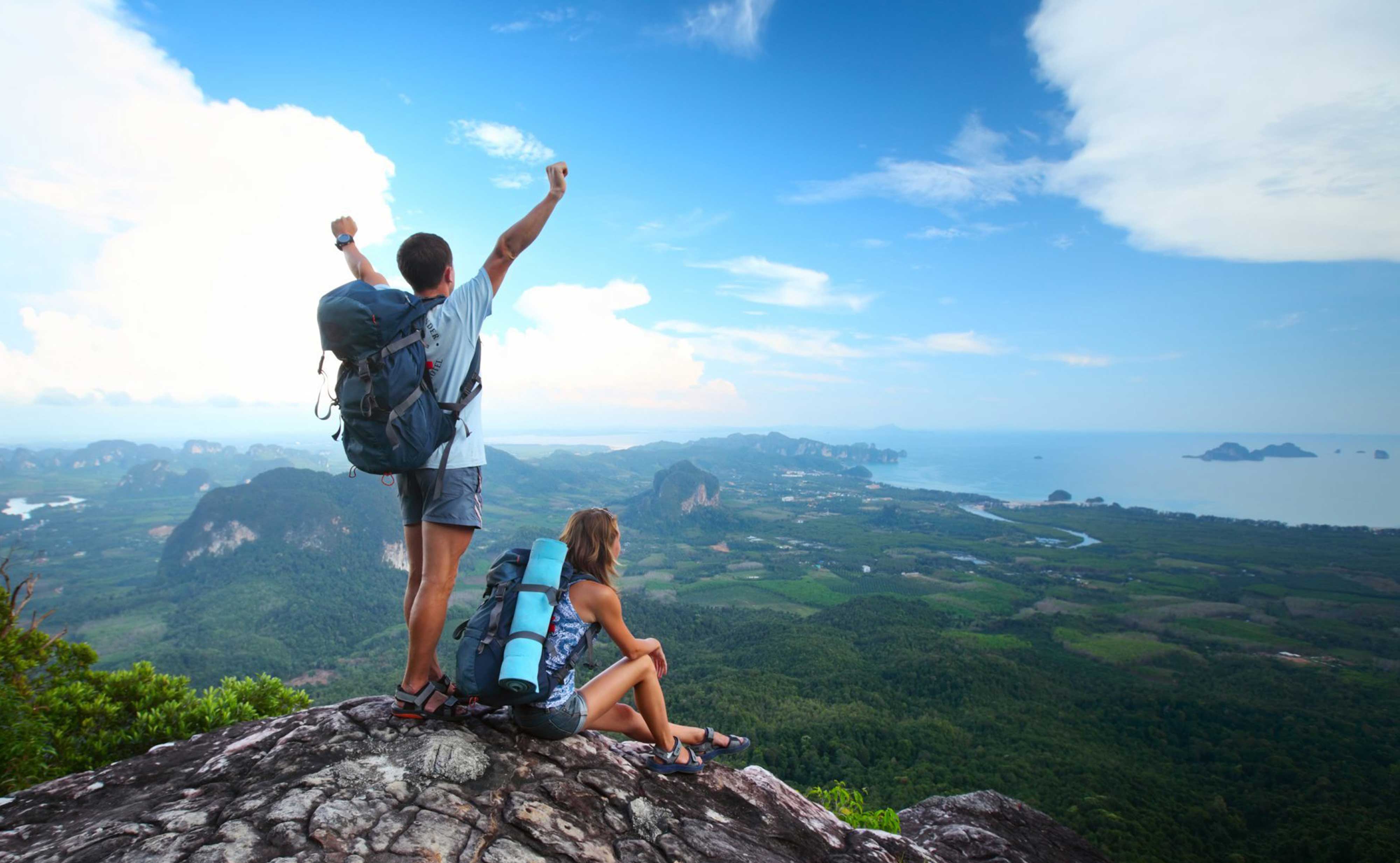 Travellers looking out over a mountain landscape